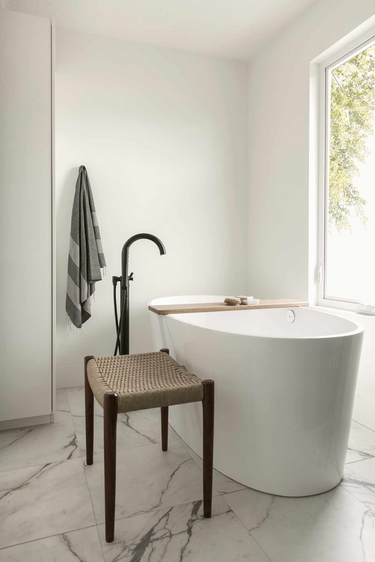 Bright white bathroom with freestanding bath after repaint